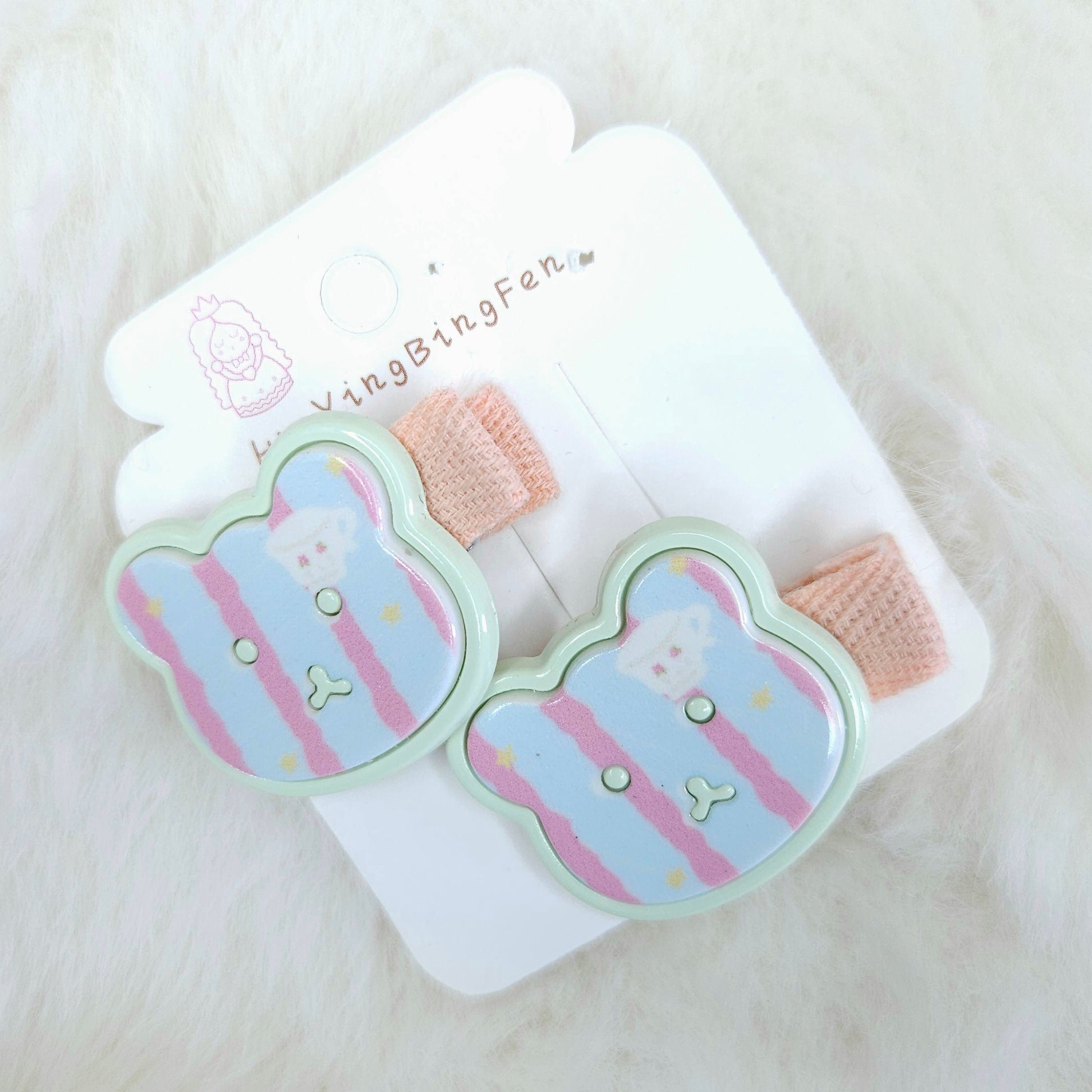 Set of cartoon bear-shaped hair clips on a white background