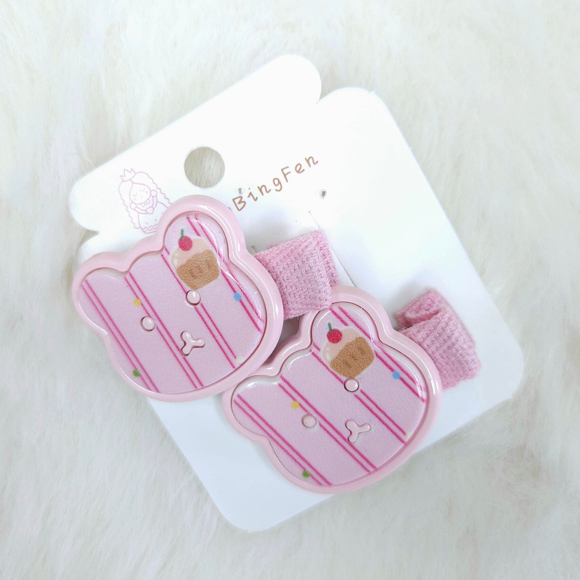 Pink hair clips with cupcake design on a white card with 'BingFan' branding, on a light pink background.