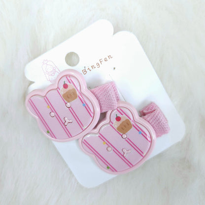 Pink hair clips with cupcake design on a white card with 'BingFan' branding, on a light pink background.
