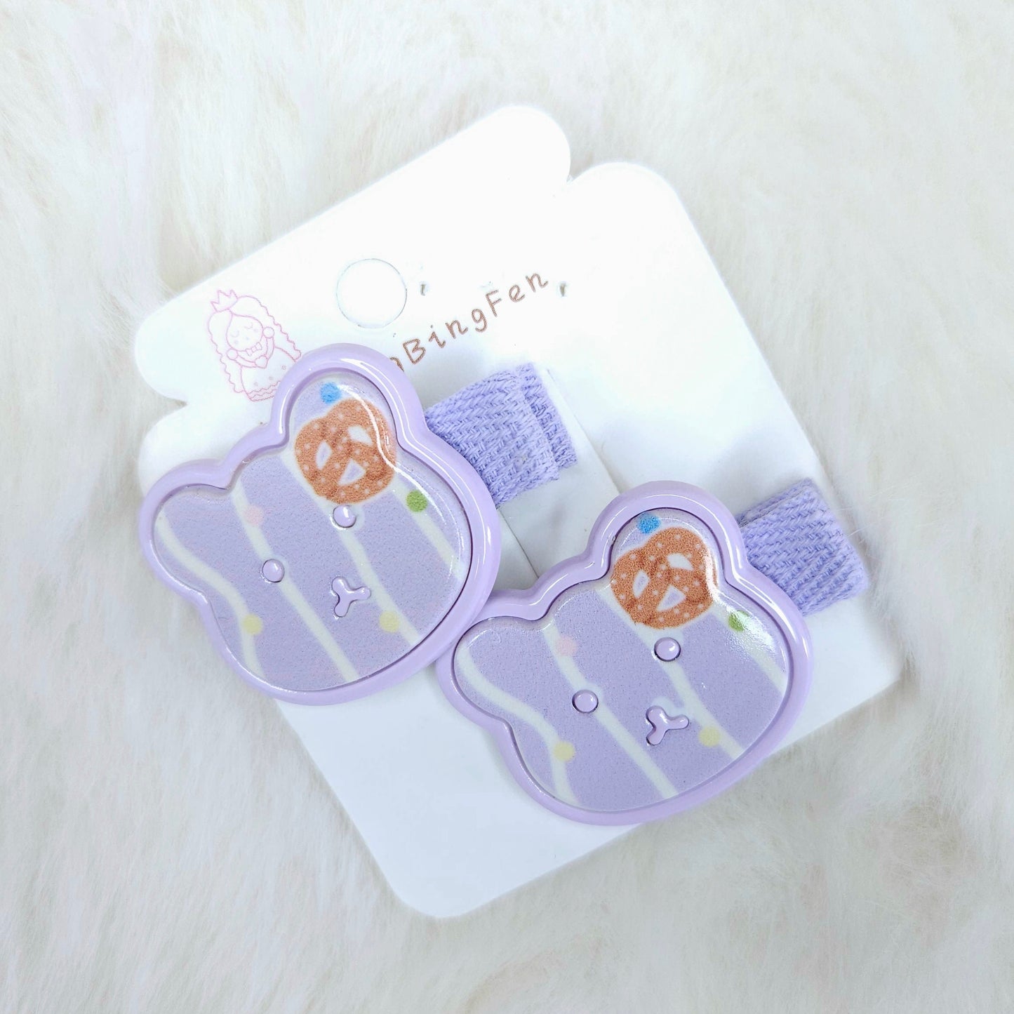 Pair of purple bear-shaped hair clips on a white card with 'BingFen' branding, on a light surface.