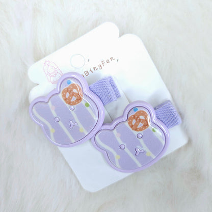 Pair of purple bear-shaped hair clips on a white card with 'BingFen' branding, on a light surface.