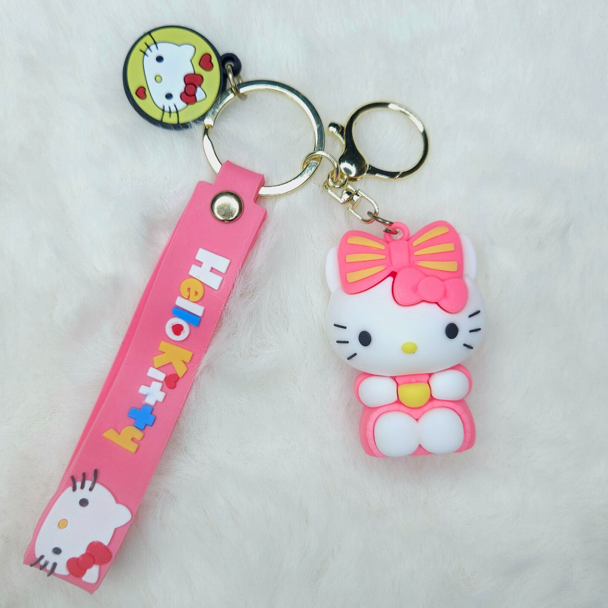 Hello Kitty keychain with pink strap on a white background