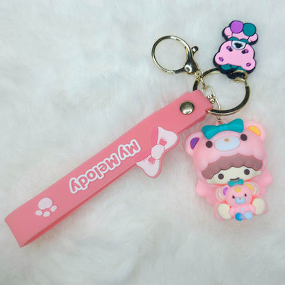 Pink keychain with cartoon character and strap on a white background
