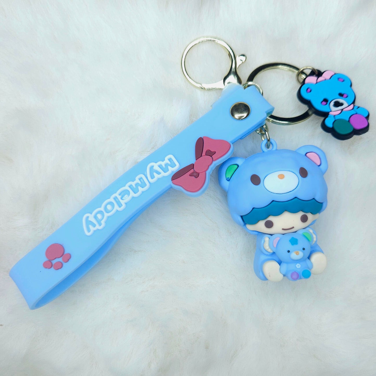 Keychain with a blue character and strap on a white background
