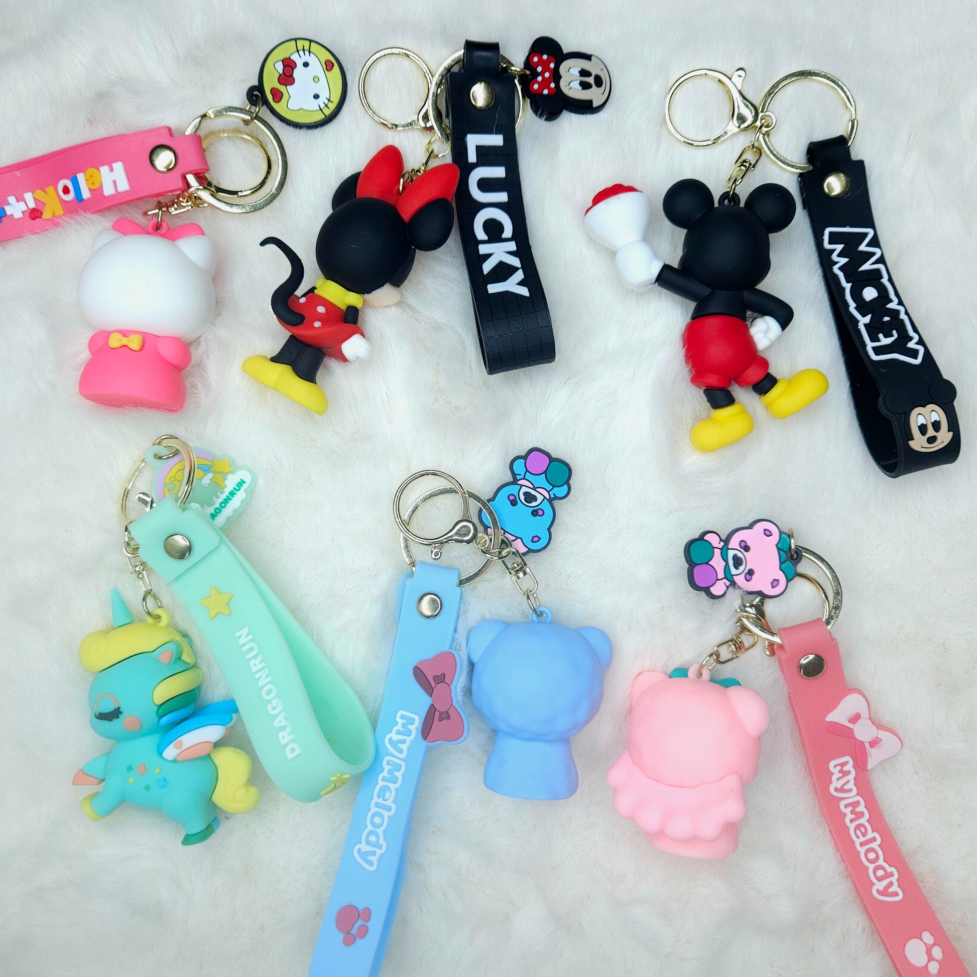 Collection of colorful keychains with various designs on a white background