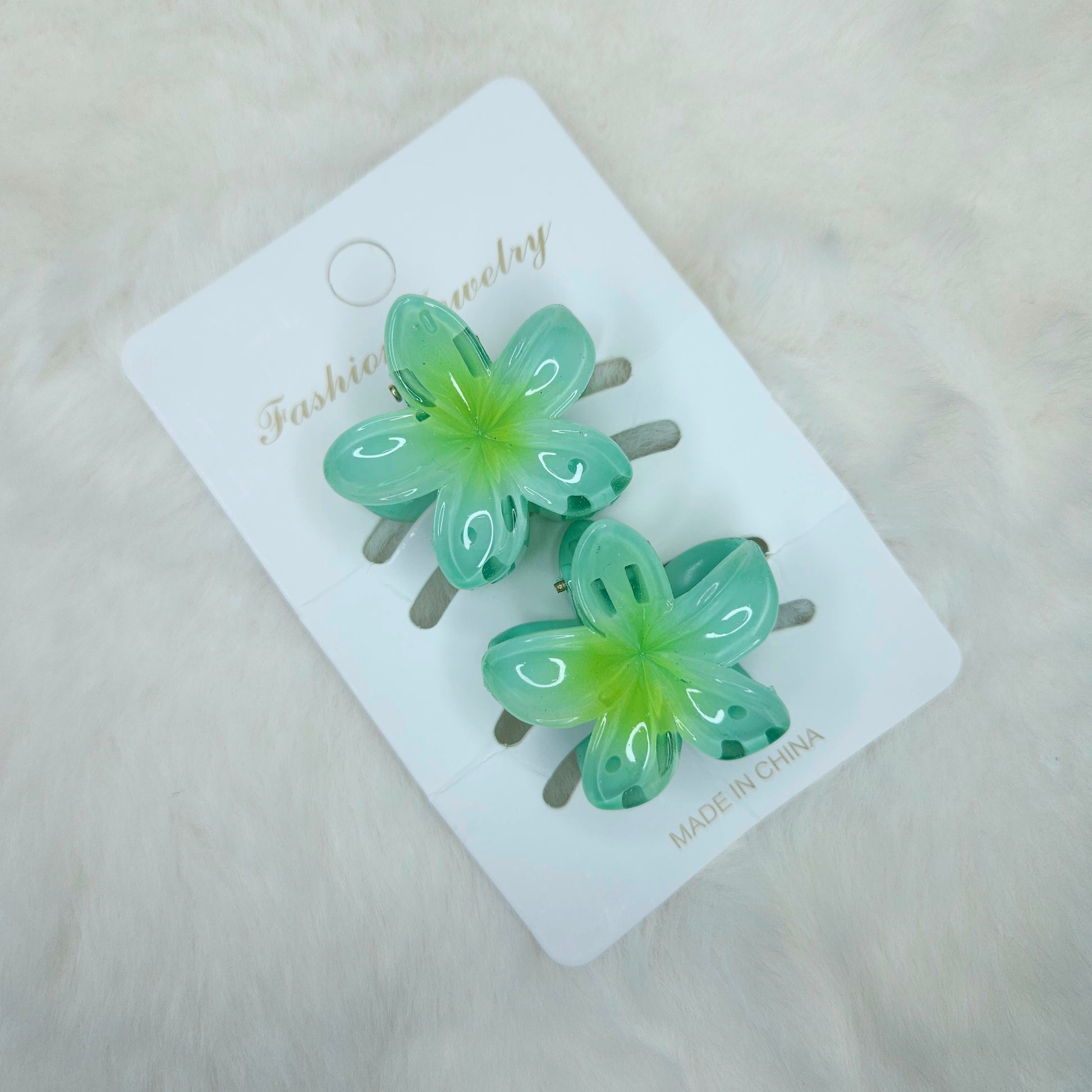 Green butterfly-shaped hair clips on a white card with 'Fashion Jewelry' branding.
