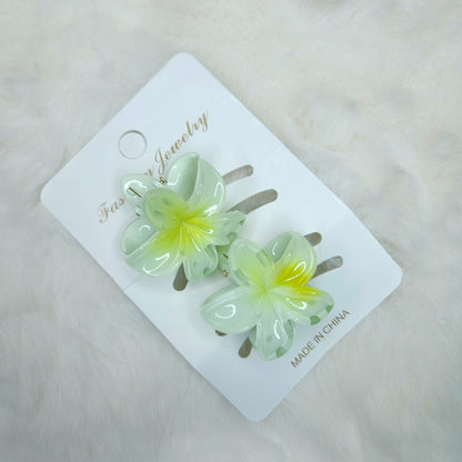 Flower-shaped hair clips on a branded card with 'Made in China' text.