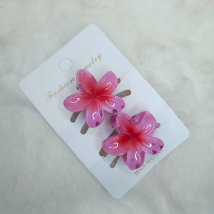 Pink flower-shaped hair clips on a white card with 'Fashion Jewelry' text.