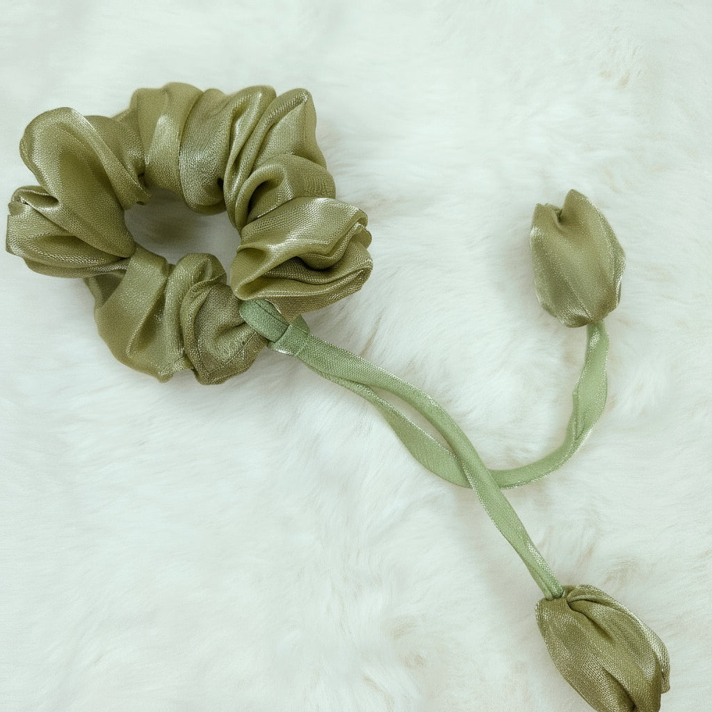 Floral green tulip scrunchie accessory with shiny finish and delicate fabric flowers.