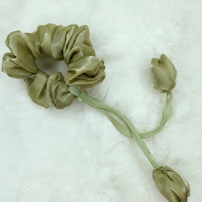 Floral green tulip scrunchie accessory with shiny finish and delicate fabric flowers.