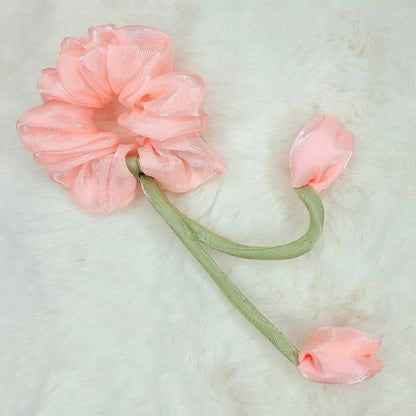 Close-up of rose colored tulip hair scrunchie with glossy finish and two fabric tulip buds.