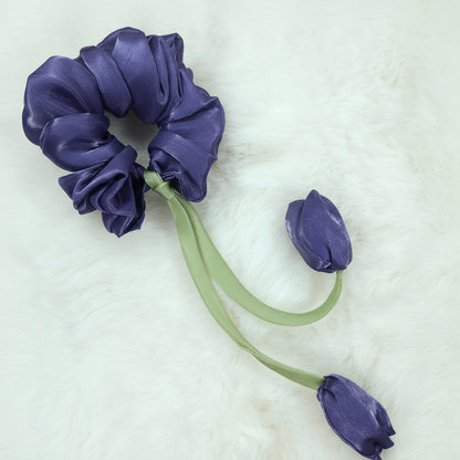 Lilac satin scrunchie with tulip flower embellishments and green ribbon ties.