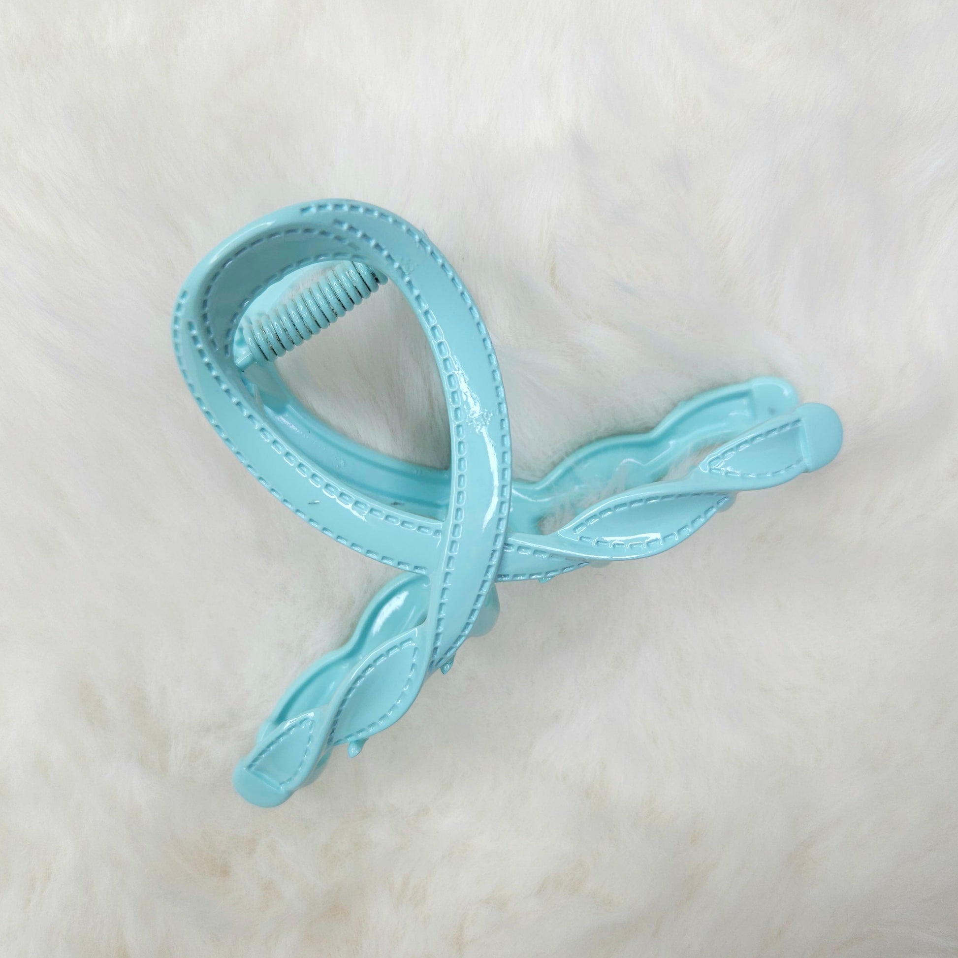Light blue hair clip on a white background
