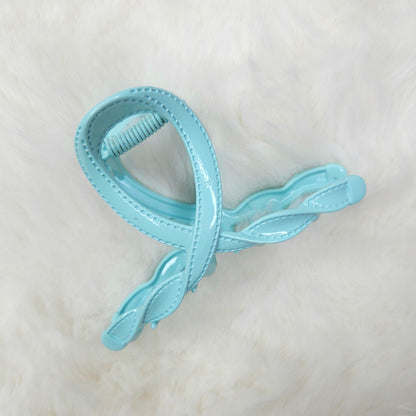 Light blue hair clip on a white background