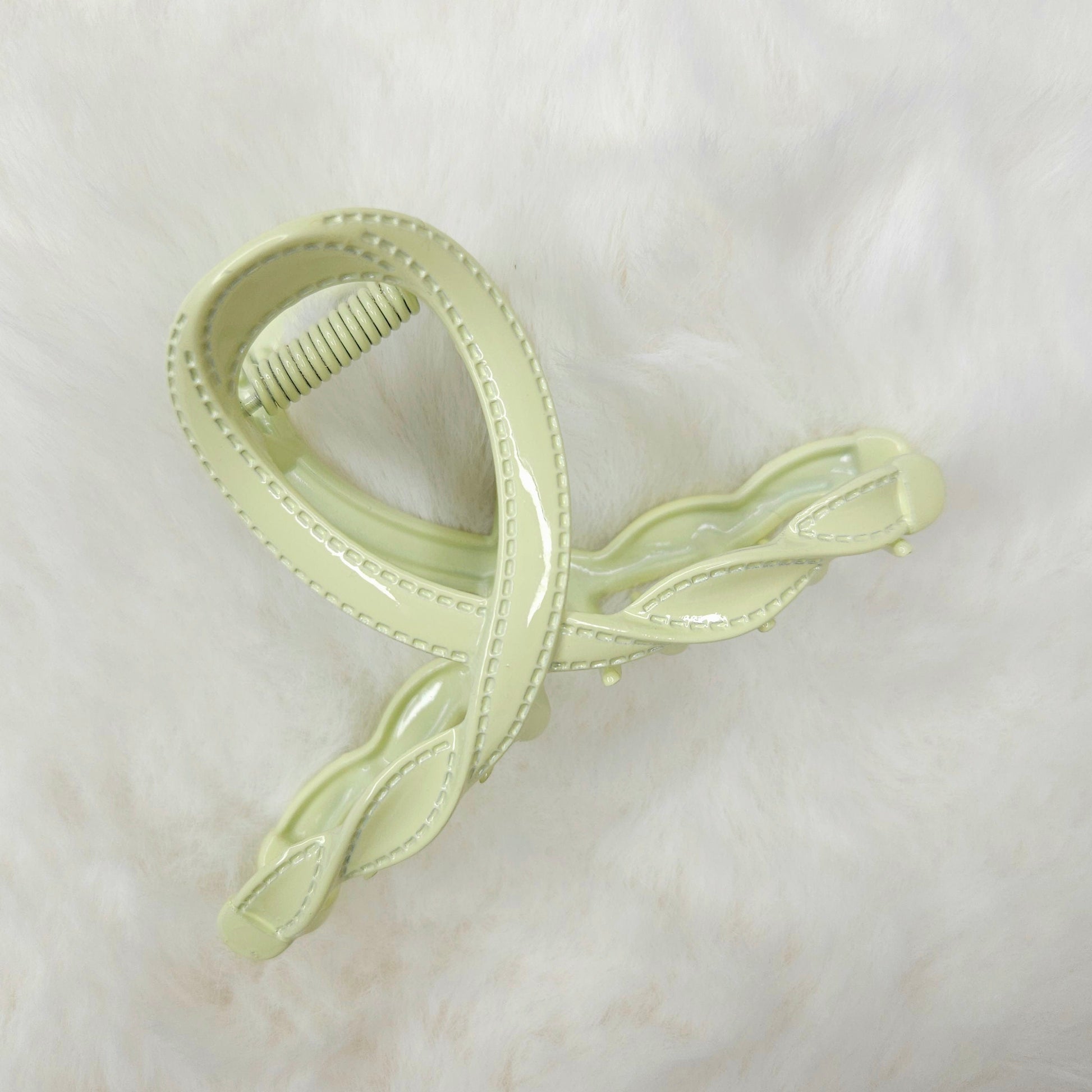 Light green hair clip on a white background