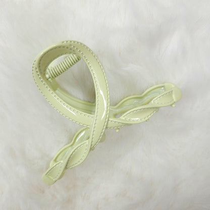Light green hair clip on a white background