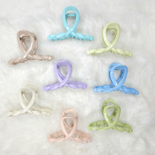 Set of pastel-colored hair clips on a white background