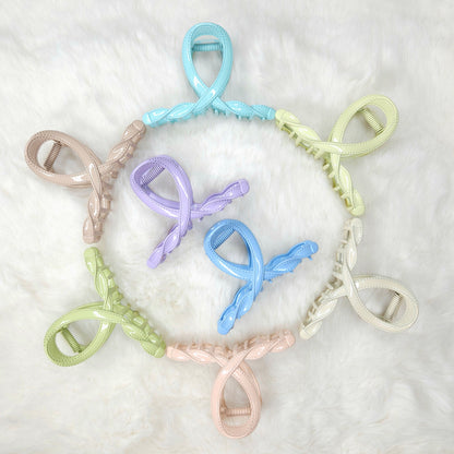 Set of colorful hair clips arranged in a circular pattern on a white background