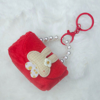 Red plush keychain with a heart and flower design on a white background